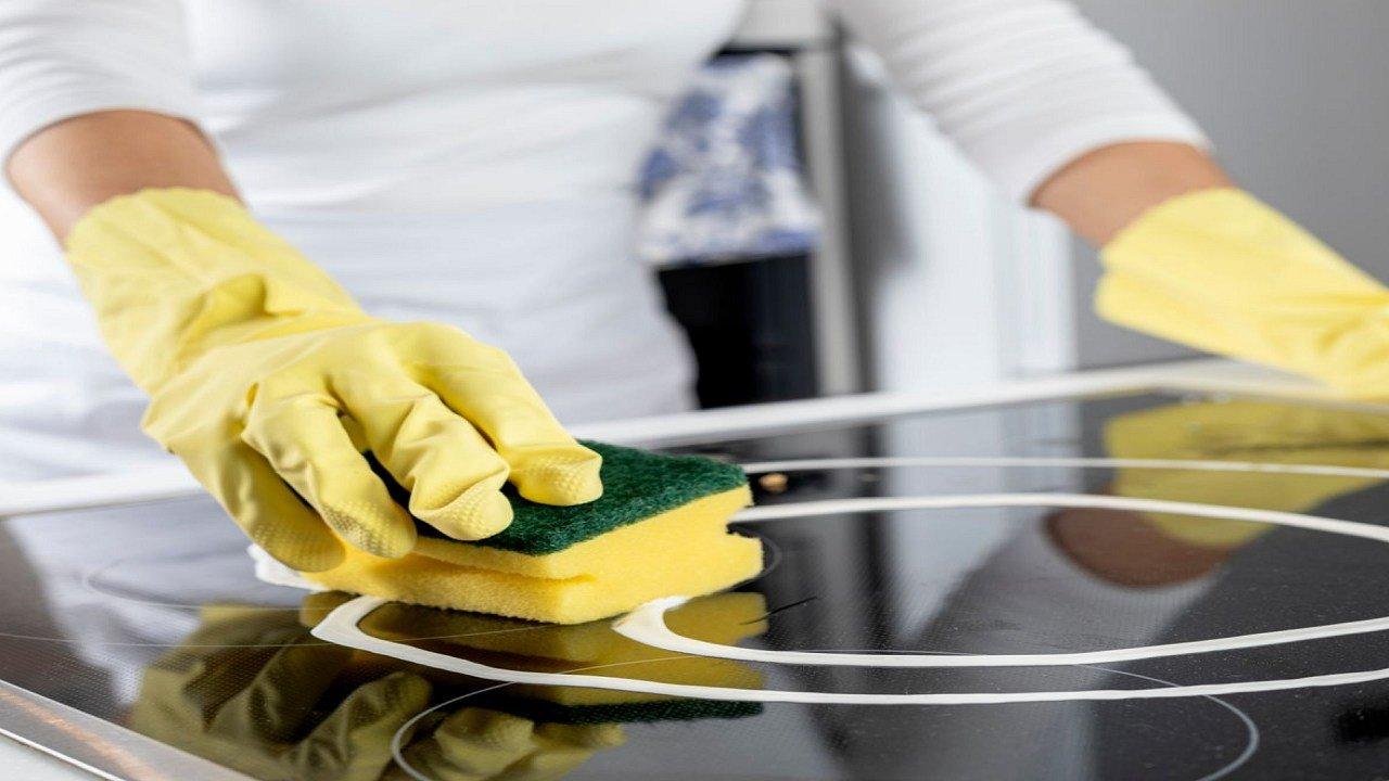 How do I remove scratches from the glass surface of my cooktop?