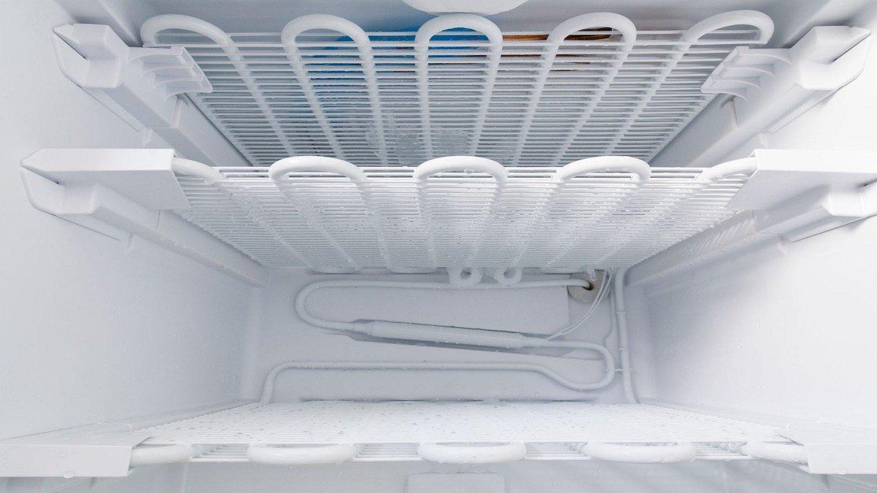 How do I fix a refrigerator with a clogged defrost drain?